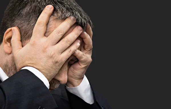Headache. Man with face closed by hands — Stock Photo, Image