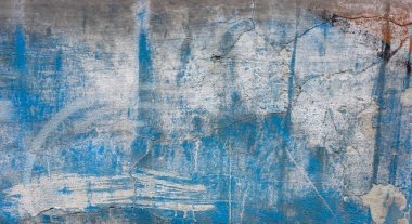 The aged wall shows signs of wear and tear, with peeling paint and visible cracks