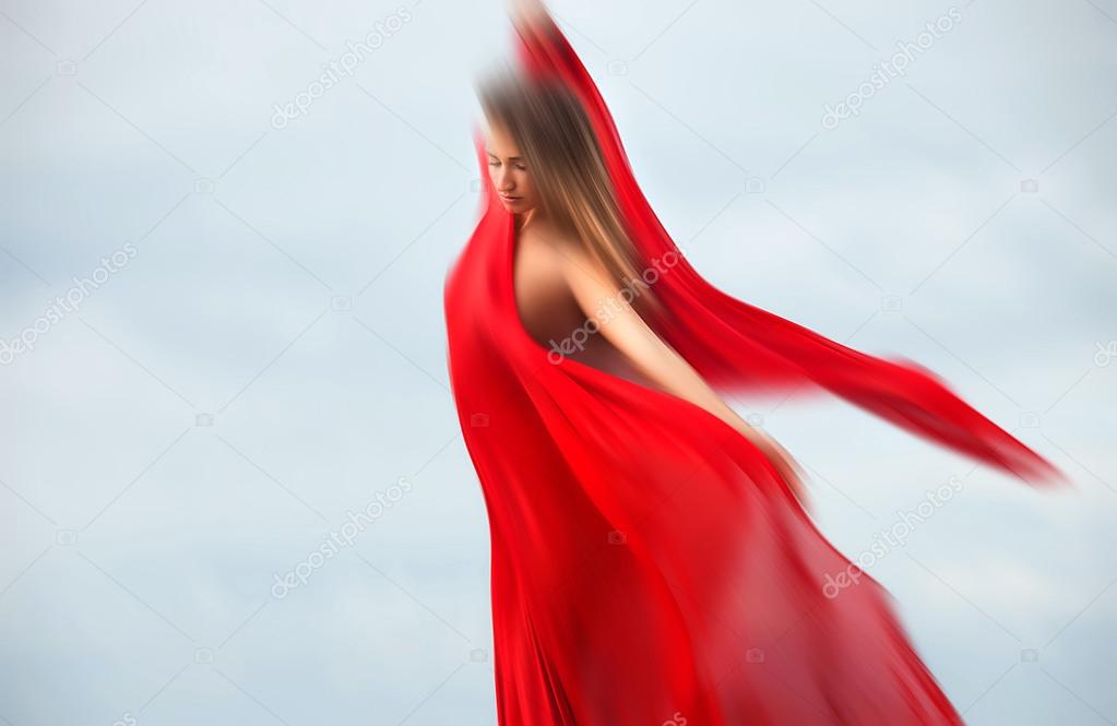 Blurred woman with red fabric