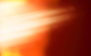 Yumuşak odaklı bir arka plan, sol üst köşeden çıkan yoğun beyaz ve turuncu ışığı, koyu kırmızı-kahverengi bir alanda köşegen ışık ışınları oluşturur..