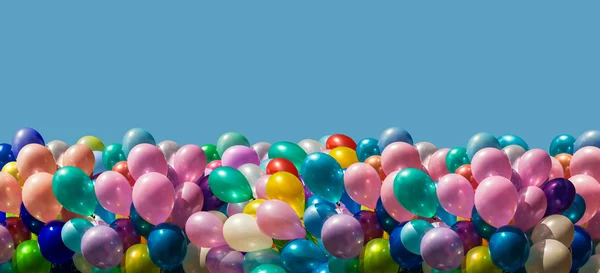 Multi-colored balloons isolated on blue — Stock Photo, Image