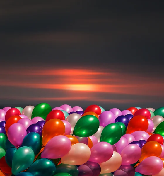 Multi-colored balloons on blurred sky background Stock Image