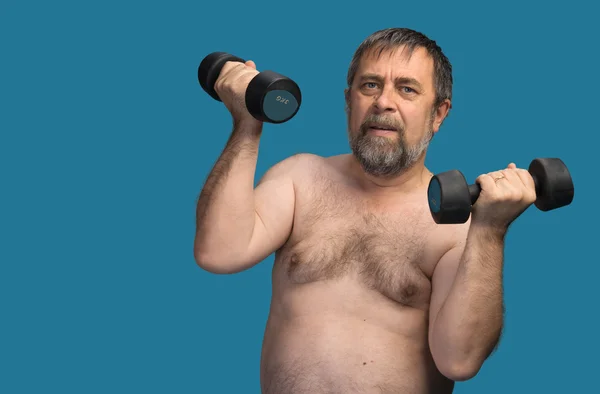 Elderly fat man exercising with dumbbells — Stock Photo, Image