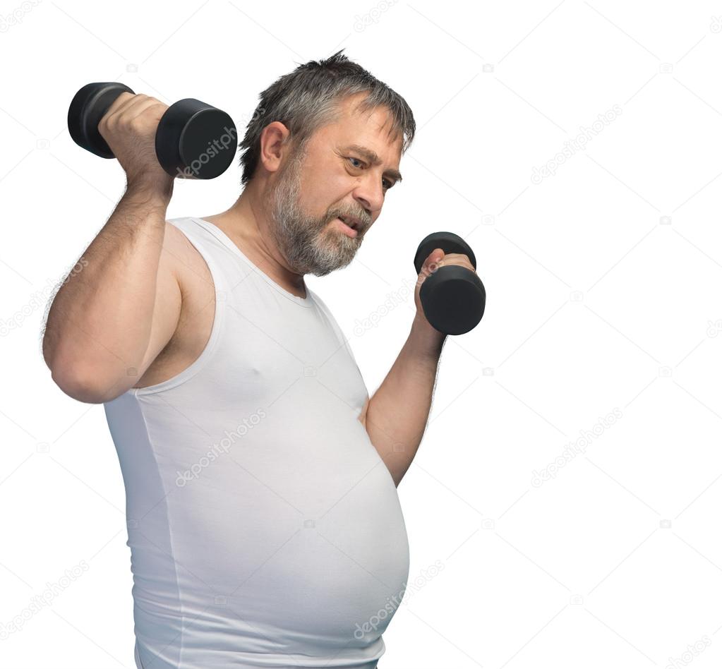 Fat middle-aged man exercising with dumbbells