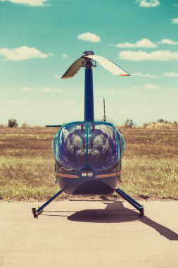 Helicopter parked at the helipad clipart