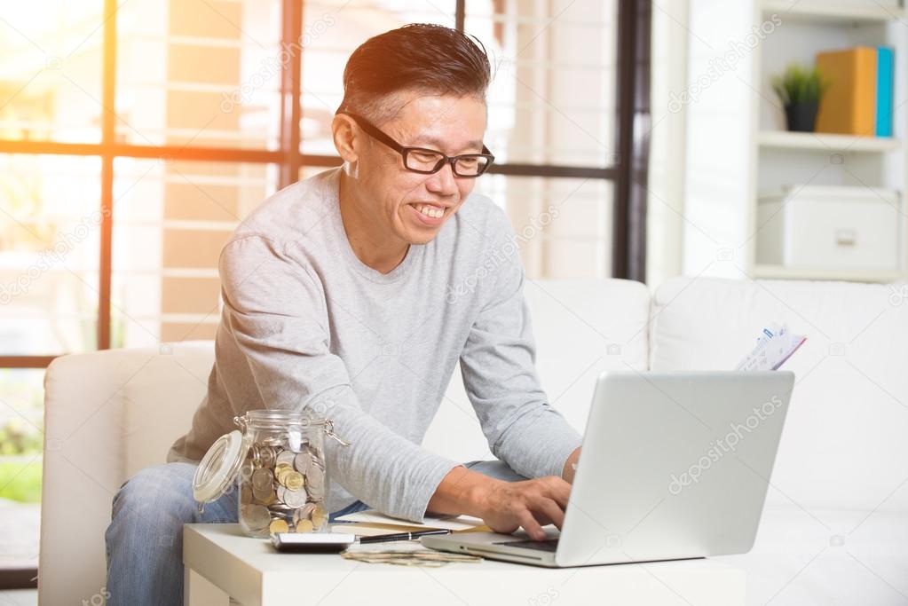 man paying bills online