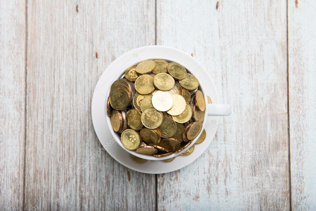 Coffee cup with gold coins