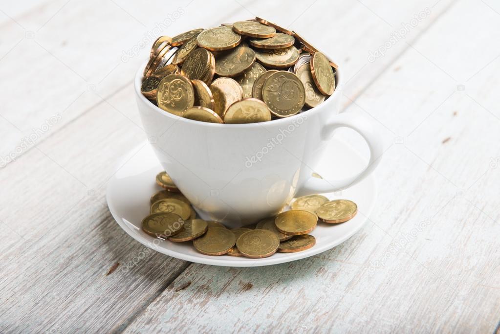 Coffee cup with gold coins