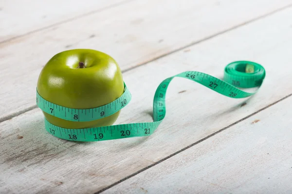 Green apples measured the meter — Stock Photo, Image