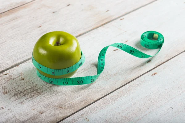 Green apples measured the meter — Stock Photo, Image