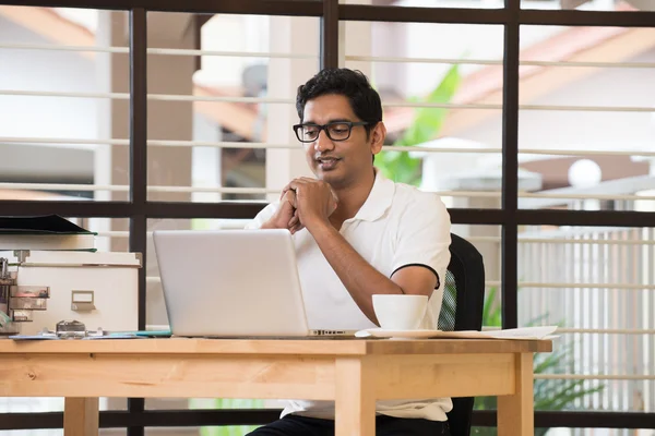 Indian man streching at office — Stock Photo, Image