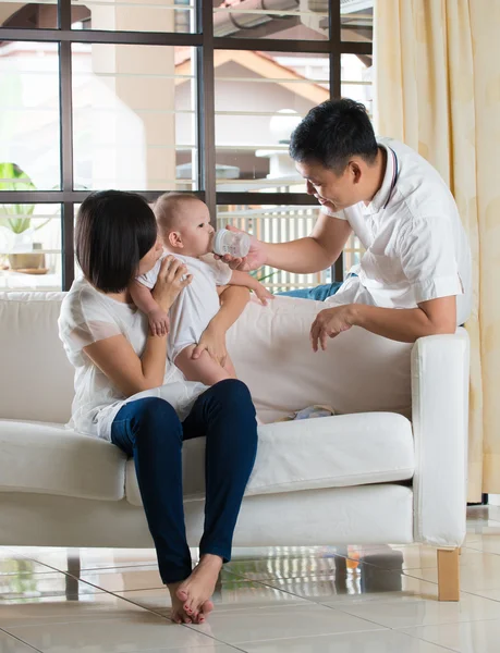 asian parents feeding toddler