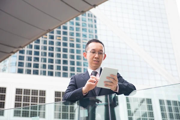 Asian businessman with tablet — Stock Photo, Image