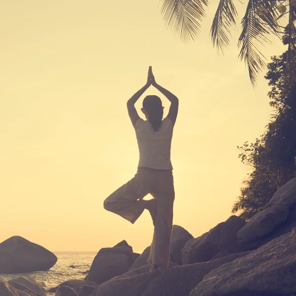 Kadın plajda yoga yapıyor. — Stok fotoğraf