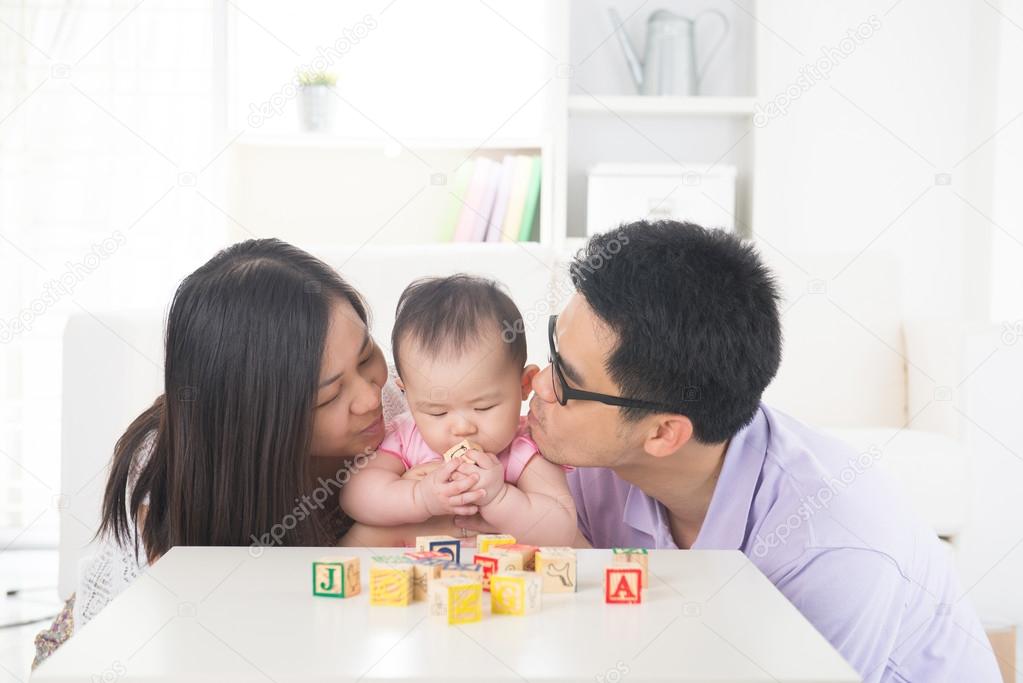 Asian parent playing with baby girl