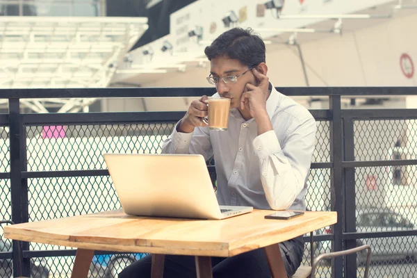 Asian Indian businessman using laptop