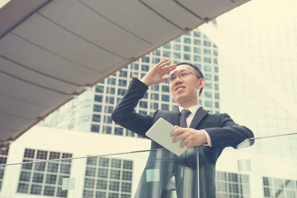 Asian Businessman using a touch pad — Stock Photo, Image