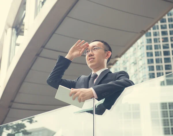 Asian Businessman using a touch pad — Stock Photo, Image