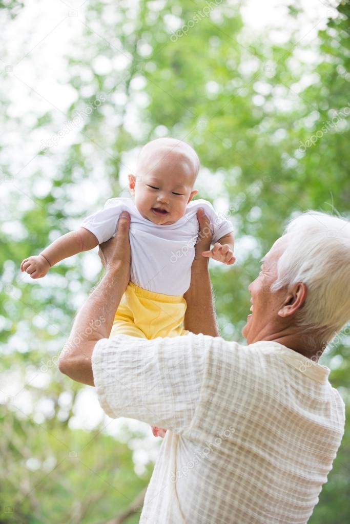 grandfather playing with baby