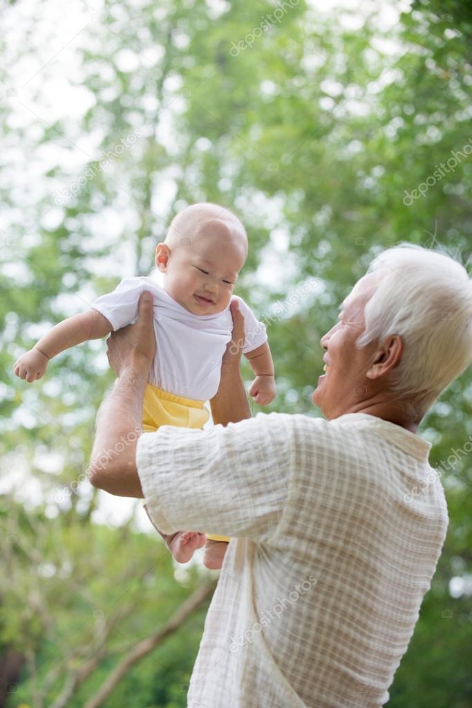 grandfather playing with baby