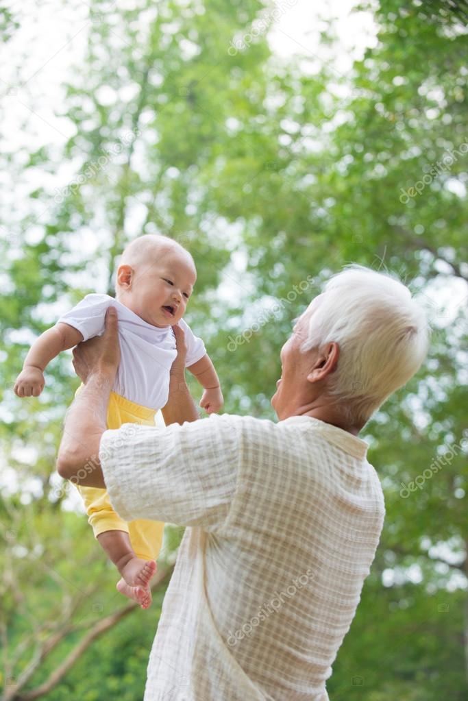 Grandparents playing with baby