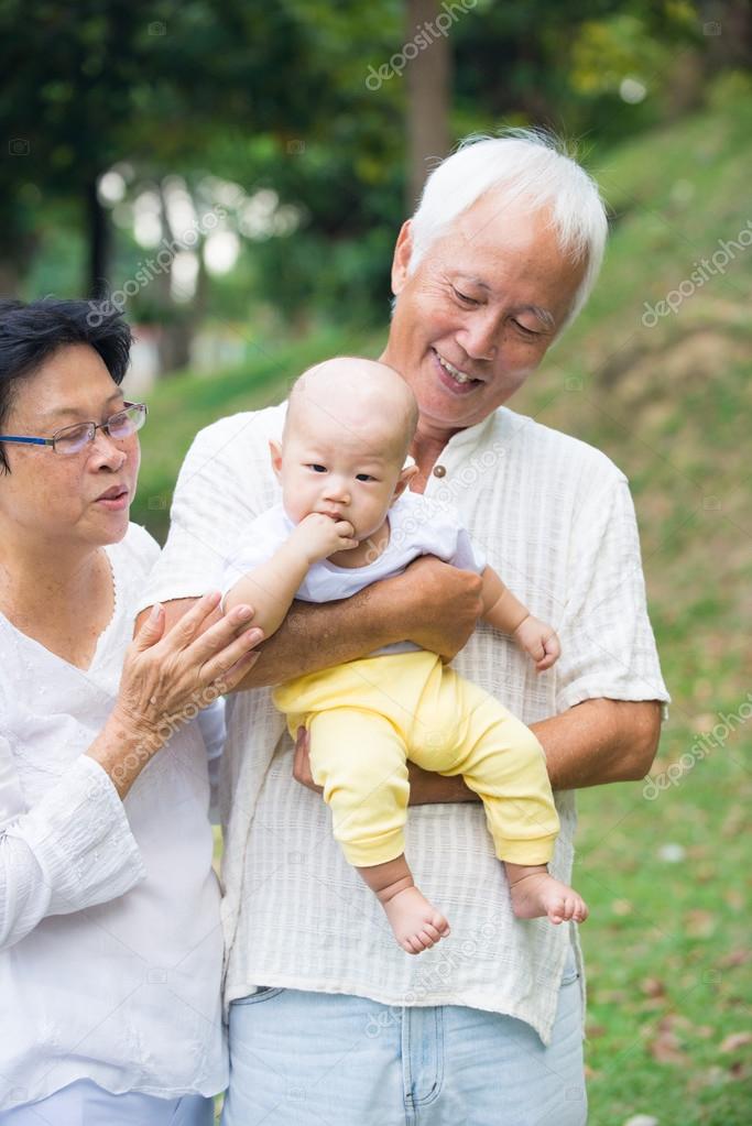 Grandparents playing with baby