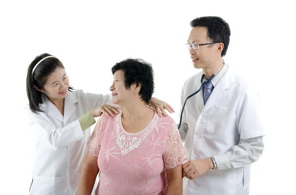 Doctor and nurse checking up patient — 图库照片