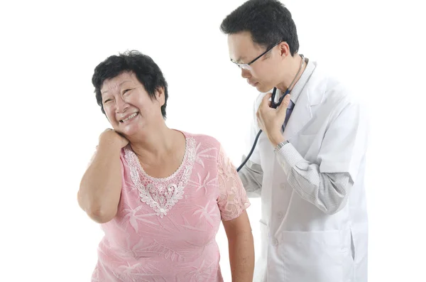 Doctor checking up a senior patient — 스톡 사진