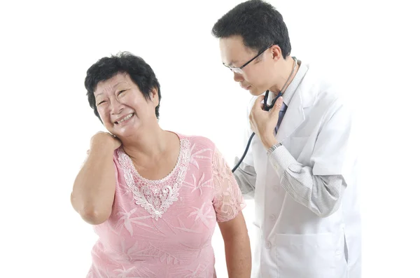 Doctor checking up a senior patient — 스톡 사진