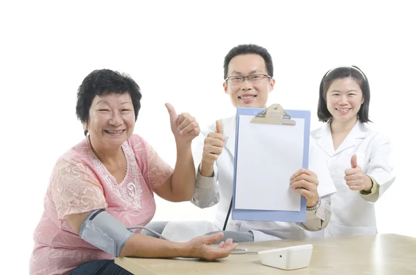 Doctor, nurse and patient giving thumbs up — Stock Photo, Image