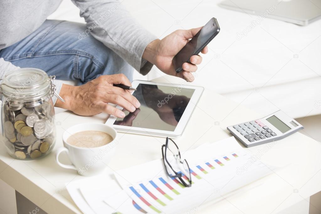 Man doing finance with tablet computer