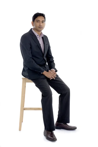 Индийский бизнесмен сидит — стоковое фото