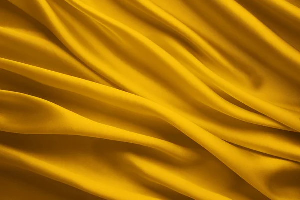 Fondo de tela de seda, sábanas de ondas de tela de satén amarillo — Foto de Stock