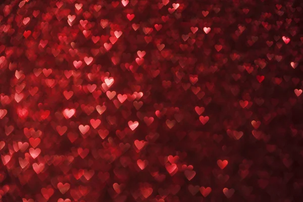 Herzen beleuchtet hintergrund, herzform de fokussiert rot funkelt — Stockfoto