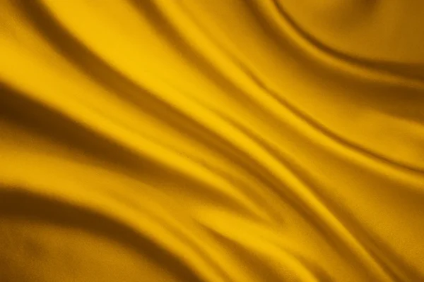 Fundo de onda de tecido de seda, textura de pano de cetim amarelo — Fotografia de Stock