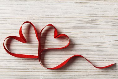 Two Hearts Shape on White Wooden Background. Valentine Day or Wedding Love Concept. Ribbon Couple