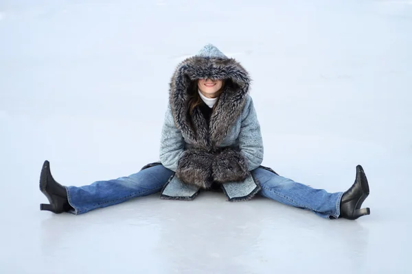 Winter woman, girl in coat on sitting on ice — Stock Photo, Image