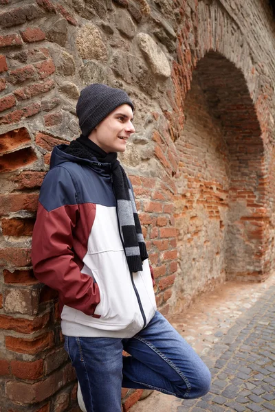 Teenage boy  near brick wall — Stock Photo, Image