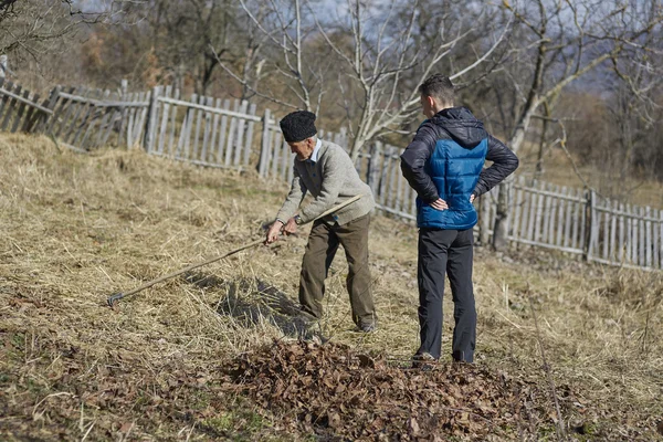 Old farmer teaching grandson — Stock Photo, Image