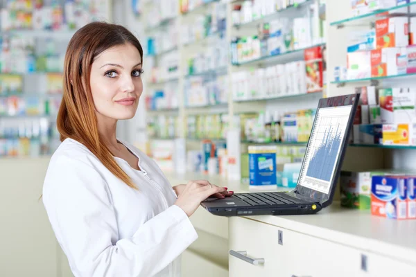 Pharmacist checking drugstore stock — Stock Photo, Image