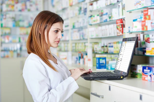 Pharmacist checking drugstore stock — Stock Photo, Image