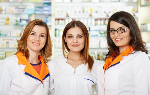 pharmacists  posing in a pharmacy