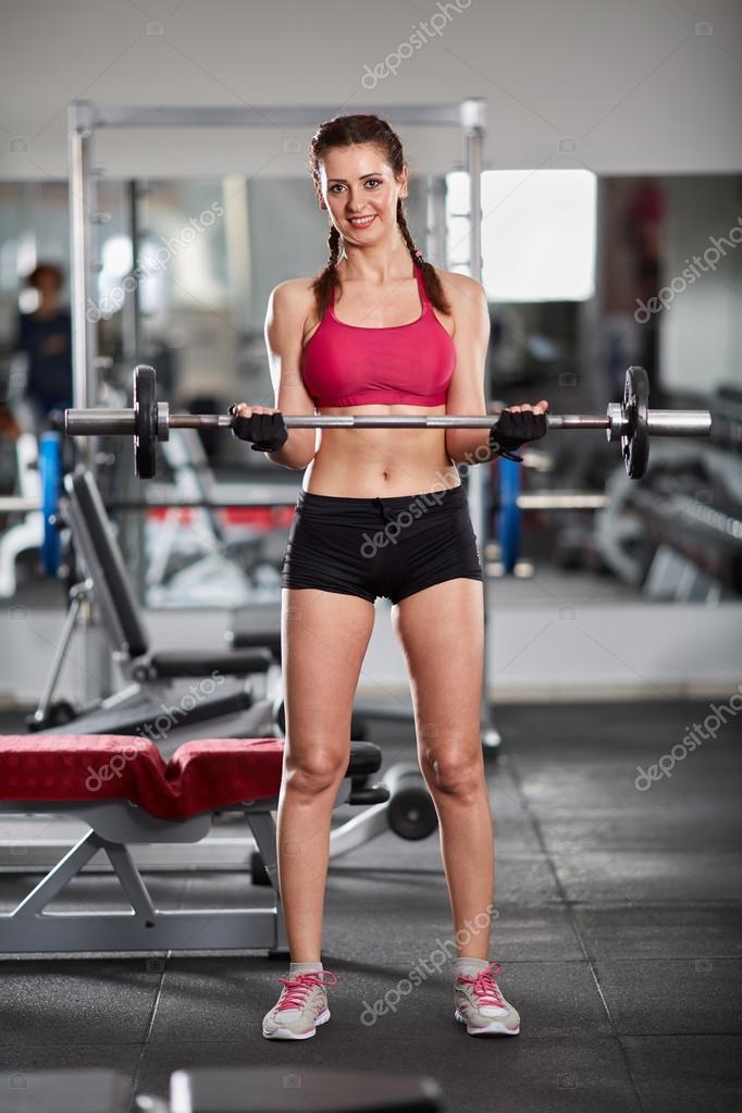 Woman doing barbell biceps curl Stock Photo Xalanx 109637284