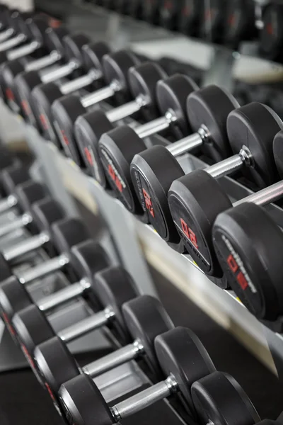 Dumbbells in the gym, on the rack — Stock Photo, Image