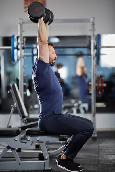 Man doing shoulder workout with dumbbells — Stock Photo, Image