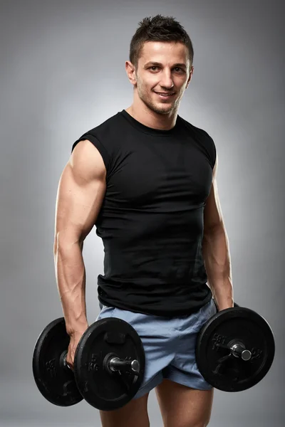 Model holding dumbbells — Stock Photo, Image