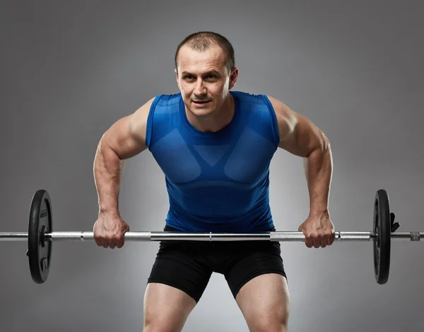 Man doing barbell rows — Stock Photo, Image