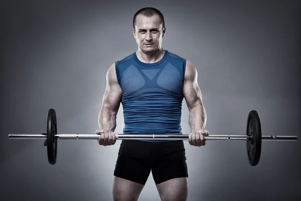 Man doing biceps curl with barbell — Stock Photo, Image