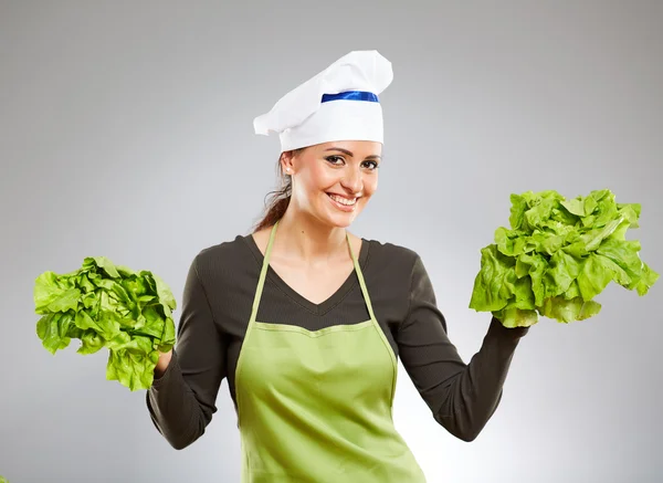 Cocinar sosteniendo grandes hojas de lechuga Fotos de stock