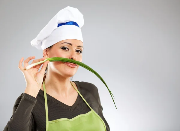 Cook making a moustache out of spring onion — Stock Photo, Image
